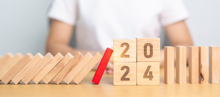 2024 year with falling blocks on table, Risk Management, recession, business financial, Resolution, strategy, goal, New Year planning and inflation economy conceptsの写真素材