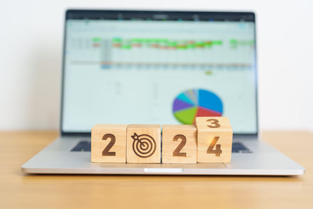 2024 Year block with dartboard icon against computer laptop background. Goal, Target, Resolution,...
