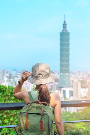 woman traveler visiting in Taiwan, Tourist looking Taipei City during sightseeing and hiking at Elephant Mountain or Xiangshan, landmark and popular attractions. Asia Travel, vacation and Trip conceptの写真素材