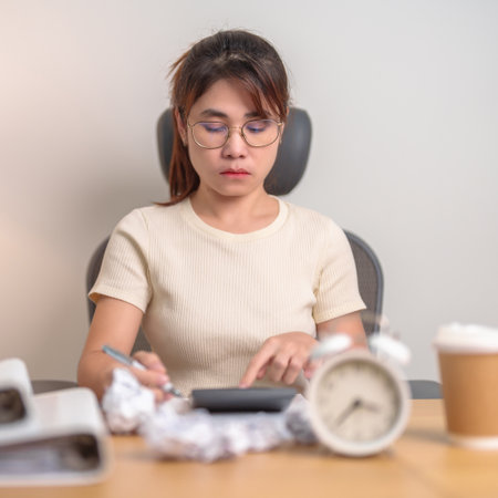 stressed Woman with mistake paper and clock, Tired female businesswoman working overload at office, Exhausted woman with document folder stack at late night in home. Failure, Problem and businessの写真素材