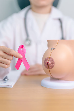 Pink October Breast Cancer Awareness month, doctor woman with pink Ribbon and Breast Anatomy model. National cancer survivors month, health diagnosis, Mother and World cancer day conceptの写真素材