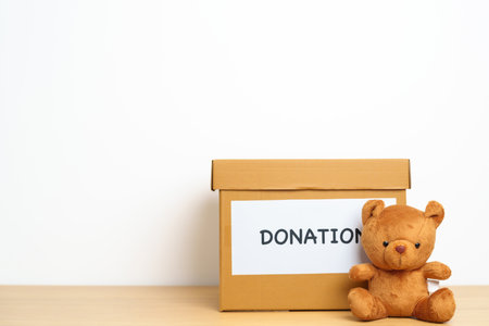 Kid Donation, Charity, Volunteer, Giving and Delivery Concept. Bear doll and Clothes with Donation...