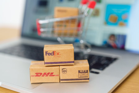 Shipping Boxes on laptop. Popular worldwide shipping and logistic company, Amazon, DHL, FedEx, UPS and OCS express delivery from online shopping. Bangkok, Thailand, 11 June 2023のeditorial素材