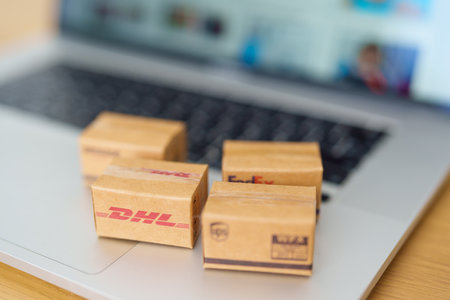 Shipping Boxes on laptop. Popular worldwide shipping and logistic company, Amazon, DHL, FedEx, UPS and OCS express delivery from online shopping. Bangkok, Thailand, 11 June 2023のeditorial素材