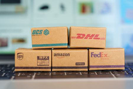 Shipping Boxes on laptop. Popular worldwide shipping and logistic company, Amazon, DHL, FedEx, UPS and OCS express delivery from online shopping. Bangkok, Thailand, 11 June 2023のeditorial素材