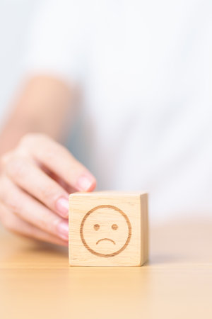 Woman show Unhappy Sad face block, Mental health Assessment, Psychology, Health Wellness, Feedback, Customer Review, Experience, Satisfaction Survey, Negative Thinking and World Mental Health dayの写真素材