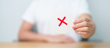 Woman show Wrong symbol paper. True and false, accept and rejected, evaluation, Vote, Poll, Yes or No and Survey conceptsの写真素材