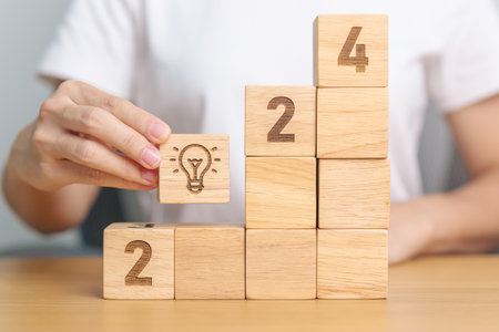 2024 block with lightbulb sign. Idea, Trends, Business Goal, Target, Resolution, strategy, plan,...