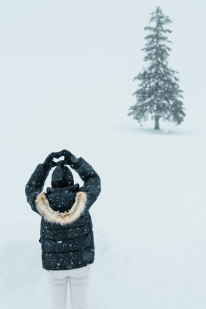 Woman tourist Visiting in Biei, Traveler in Sweater sightseeing Christmas tree with Snow in winter season. landmark and popular for attractions in Hokkaido, Japan. Travel and Vacation conceptの写真素材