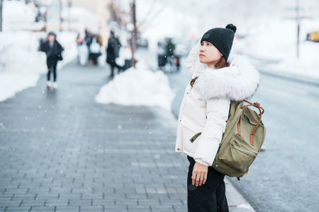 Woman tourist sightseeing in Niseko city with Snow in winter season. landmark and popular for attractions in Hokkaido, Japan. Travel and Vacation conceptの写真素材
