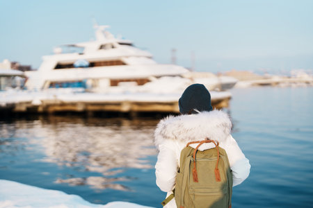 Woman tourist Visiting in Hakodate, Traveler in Sweater sightseeing Hakodate port near Red Brick Warehouse with Snow in winter. Hokkaido, Japan.Travel and Vacation conceptの写真素材