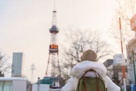 Woman tourist Visiting in Sapporo, Traveler in Sweater sightseeing Sapporo tower with Snow in winter. landmark and popular for attractions in Hokkaido, Japan. Travel and Vacation conceptの写真素材