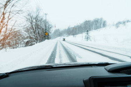 Beautiful snow road forest view during car driving in winter season. Winter travel, Road trip, Adventure, Exploring and Vacation conceptsの写真素材