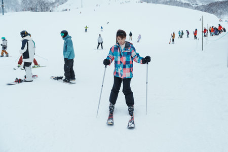 Young woman playing Ski in winter season. Snow winter activity conceptの写真素材
