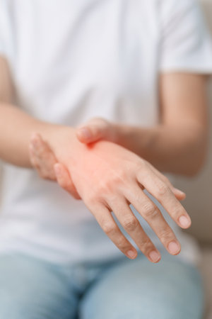Woman having wrist pain during sitting on sofa at home, muscle ache due to De Quervain s tenosynovitis, ergonomic, Carpal Tunnel Syndrome or Office syndrome conceptの写真素材