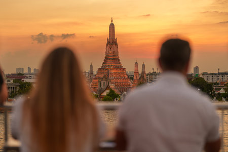 Wat Arun Temple in sunset, Tourists enjoy the view to Temple of Dawn near Chao Phraya river. Take photo from rooftop bar. Landmark and Travel destination in Bangkok, Thailand and Southeast Asiaの写真素材