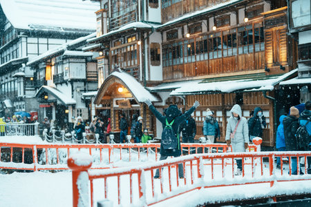 Beautiful Ginzan Onsen with snow fall in winter season is most famous Japanese Hot Spring in Yamagata, Japan. Yamagata, Japan, 24 January 2024のeditorial素材