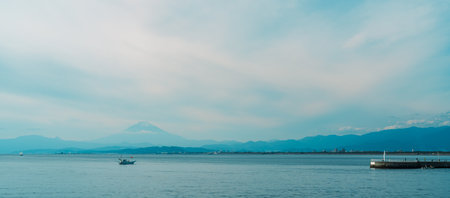 Scenery Kamakura Yuigahama Beach with Kamakura city and Fujisan mountain. Mount Fuji behind Enoshima island at Kamakura, Kanagawa, Japan. Landmark for tourist attraction near tokyoの写真素材