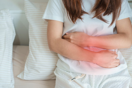 woman having abdomen ache due to Stomach pain, digestion with constipation or Diarrhea from food poisoning, female problem and Endometriosis, Hysterectomy and Menstrual on the bed at homeの写真素材