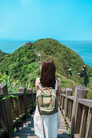 woman traveler visiting in Taiwan, Tourist with backpack sightseeing in Bitou Cape Hiking Trail, New...