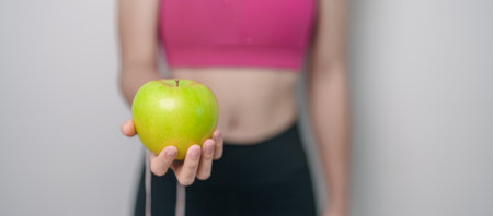 woman hand hold green Apple, happy female fitness choose fruit is Healthy food. Dieting control, Weight loss, Obesity, eating lifestyle and nutrition conceptsの写真素材