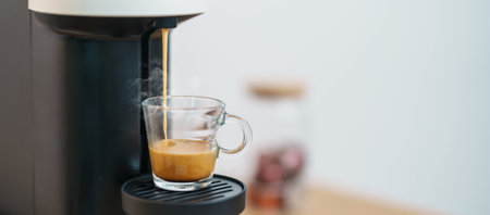 Espresso cup with steam and froth during Coffee making Coffee by Coffee Maker Machine on wood table bar. Cafe shop, Daily beverage drink at Home, Apartment and Office conceptの写真素材