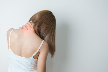 Woman having Neck and Shoulder pain at home. Muscle painful due to Myofascial pain syndrome and Fibromyalgia, rheumatism, Scapular pain, Cervical Spine. ergonomic conceptの写真素材