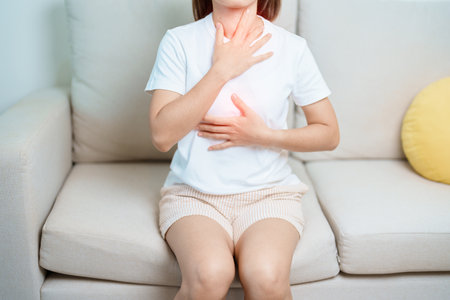 Gastroesophageal Reflux Disease or GERD, Acid reflux disease, Gastro Oesophageal or GORD and Dyspepsia concept. woman having Stomach ache and Esophageal pain due to Digestion system problemの写真素材