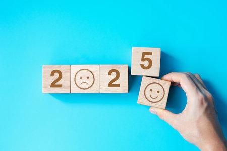 Smile face block with 2025  text on blue background. Satisfaction, feedback, Review and New Year conceptsの写真素材