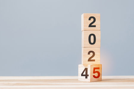 2024 chang to 2025 wooden cube blocks on table background. Resolution, plan, review, goal, start, end year  and New Year holiday conceptsの写真素材