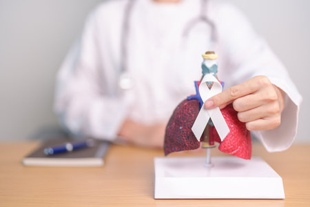 November Lung Cancer Awareness month. Doctor with Smoker Lung anatomy model and White ribbon in hospital. Healthcare and World Cancer day conceptの写真素材