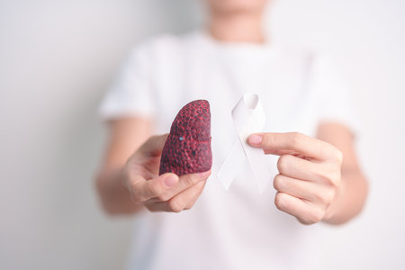 November Lung Cancer Awareness month. Doctor with Smoker Lung anatomy model and White ribbon in hospital. Healthcare and World Cancer day conceptの写真素材