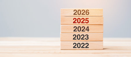 2026 block over 2025 and 2024 wooden building on table background. Business planning, Risk Management, Resolution, strategy, solution, goal, New Year New You and happy holiday conceptsの写真素材