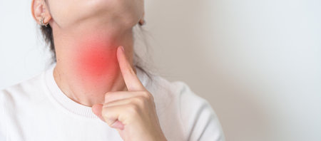 Woman checking Thyroid gland disease. Hand holding Neck pain. Hyperthyroidism, Hypothyroidism, Hashimoto Thyroiditis, Thyroid Tumor and Cancer, Postpartum, Papillary Carcinoma and Health conceptの写真素材