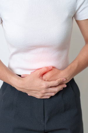 Woman having Stomach pain. Ovarian and Cervical cancer, Cervix disorder, Endometriosis, Hysterectomy, Uterine fibroids, Reproductive system, menstruation, diarrhea, digestive system and Pregnancyの写真素材