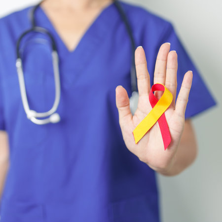 World hepatitis day awareness month, 28 July. Doctor holding Red and Yellow ribbon. Liver cancer,...