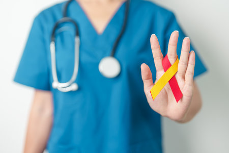 World hepatitis day awareness month, 28 July. Doctor holding Red and Yellow ribbon. Liver cancer, Jaundice, Cirrhosis, Failure, Enlarged, Hepatic Encephalopathy and Health conceptの写真素材