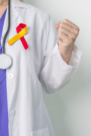 World hepatitis day awareness month, 28 July. Doctor holding Red and Yellow ribbon. Liver cancer, Jaundice, Cirrhosis, Failure, Enlarged, Hepatic Encephalopathy and Health conceptの写真素材