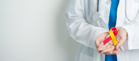 World hepatitis day awareness month, 28 July. Doctor holding Red and Yellow ribbon. Liver cancer, Jaundice, Cirrhosis, Failure, Enlarged, Hepatic Encephalopathy and Health conceptの写真素材