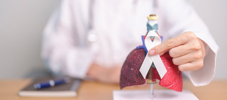 November Lung Cancer Awareness month. Doctor with Smoker Lung anatomy model and White ribbon in hospital. Healthcare and World Cancer day conceptの写真素材