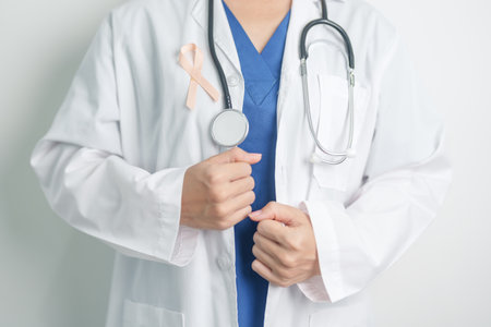 Doctor holding Peach Ribbon for September Uterine Cancer Awareness month. Uterus and Ovaries, Endometriosis, Hysterectomy, Uterine fibroids, Reproductive, Healthcare and World cancer day conceptの写真素材