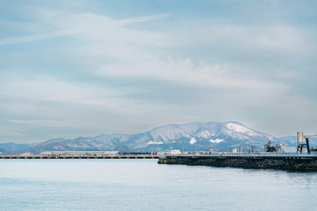 view of ocean and mountains with snow in winter at Aomori Bay Bridge Locate in the city of Aomori in...