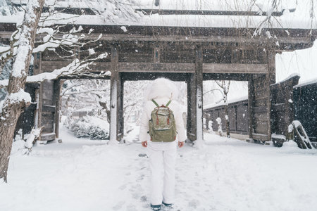 Woman tourist sightseeing Yamadera temple with snow in winter, traveler travel Risshakuji temple in Yamagata City, in Yamagata Prefecture, Tohuku, Japan. Landmark for tourists attraction in Japanの写真素材