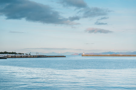 view of ocean and mountains with snow in winter at Aomori Bay Bridge Locate in the city of Aomori in Aomori Prefecture, Japanの写真素材