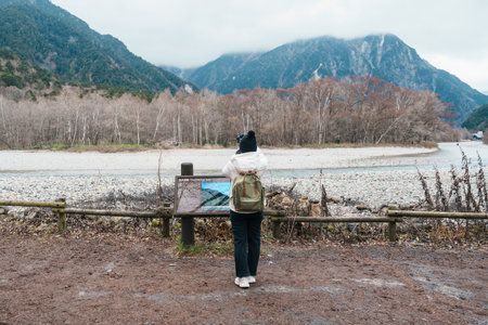 Woman tourist travel Kamikochi National Park, happy Traveler sightseeing Azusa river with mountain,...