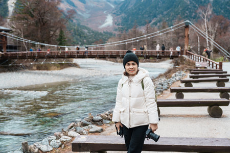 Woman tourist travel Kamikochi National Park, happy Traveler sightseeing Kappa bashi bridge, Nagano...