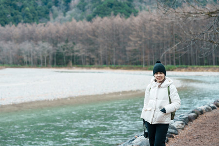 Woman tourist travel Kamikochi National Park, happy Traveler sightseeing Azusa river with mountain, Nagano Prefecture, Japan. Landmark for tourists attraction. Japan Travel, Destination and Vacationの写真素材