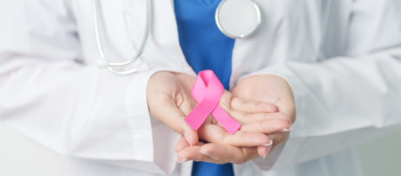 Pink October Breast Cancer Awareness month, woman doctor with pink Ribbon in hospital for support people life and illness. National cancer survivors month, Mother and World cancer day conceptの写真素材