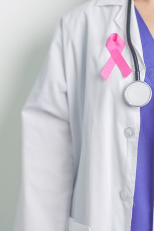Pink October Breast Cancer Awareness month, woman doctor with pink Ribbon in hospital for support people life and illness. National cancer survivors month, Mother and World cancer day conceptの写真素材