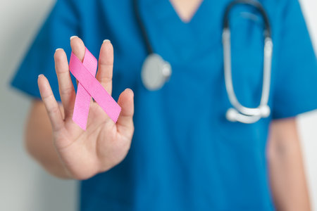 Pink October Breast Cancer Awareness month, woman doctor with pink Ribbon in hospital for support people life and illness. National cancer survivors month, Mother and World cancer day conceptの写真素材
